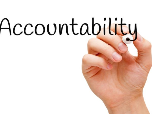 Hand writing Accountability with black marker on transparent wipe board.